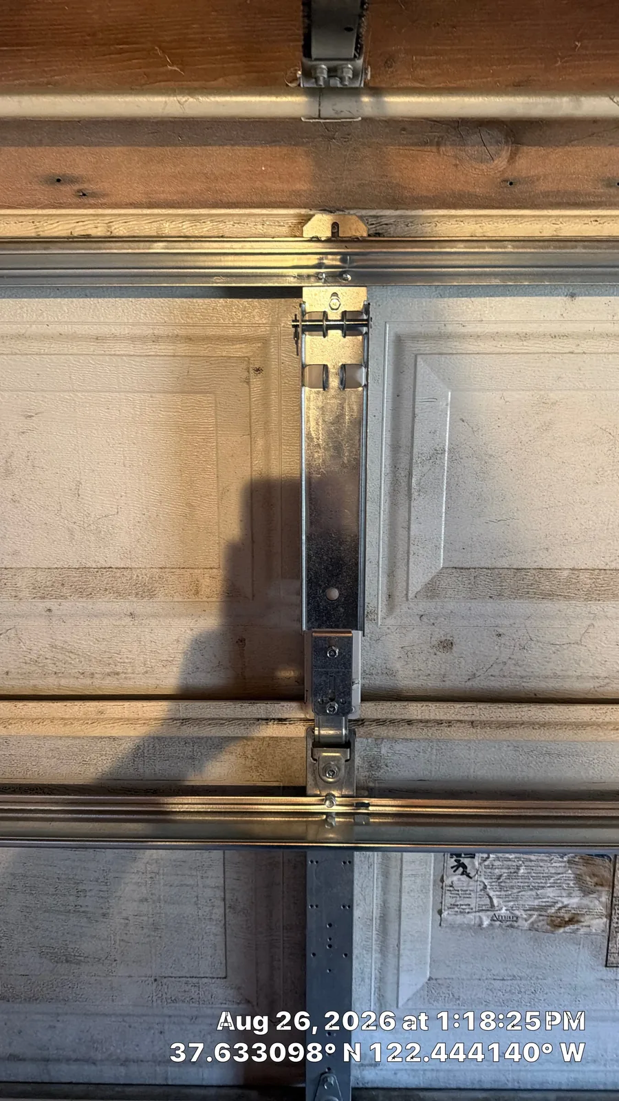 Reinforced operator bracket installed after the center stile repair.